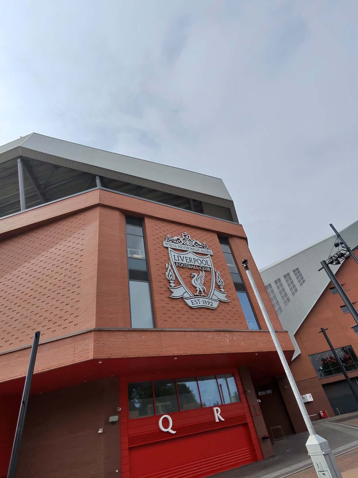 The Liverpool FC crest on the Anfield stadium exterior