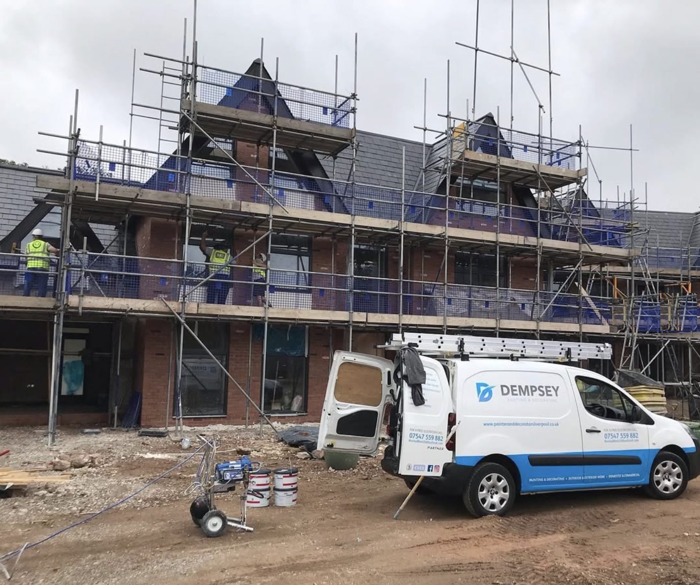 The Dempsey Painting & Decorating van on a scaffolded site