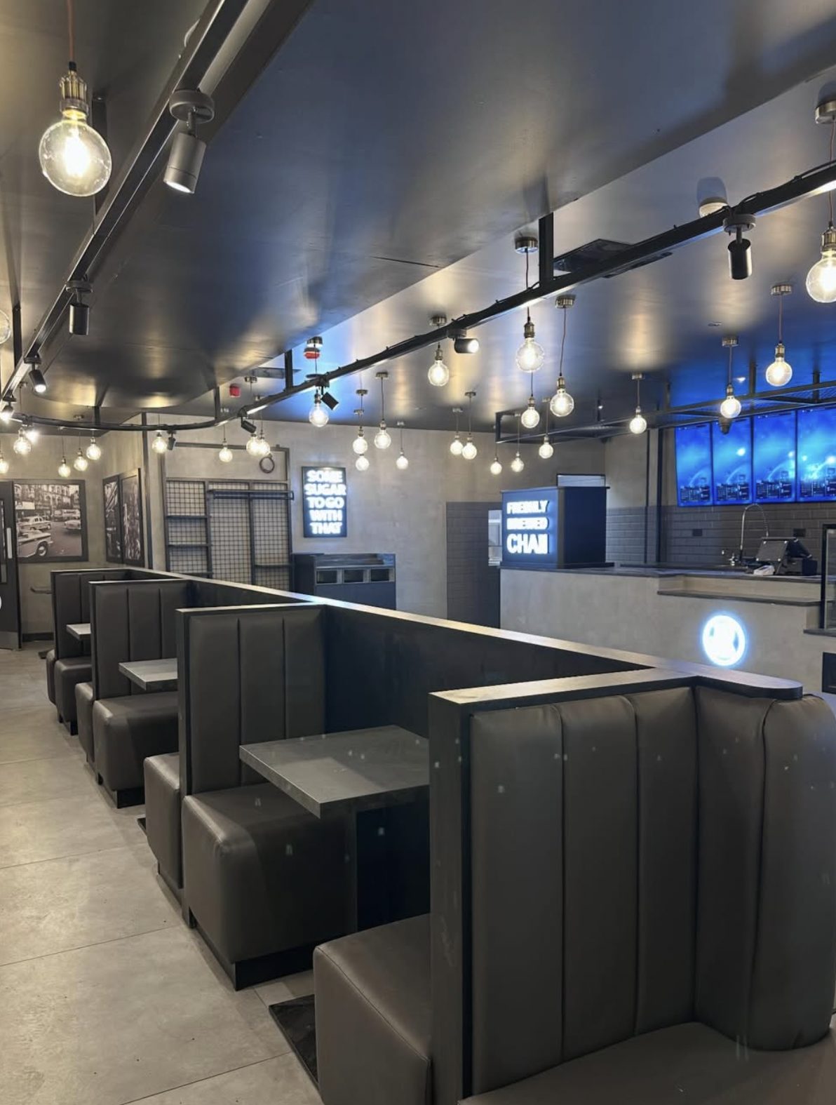 Booth seating under pendant lighting inside Chaiiwala